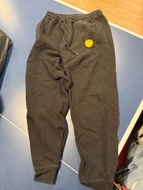 Black Sweatpants with Yellow Smiley Patch
